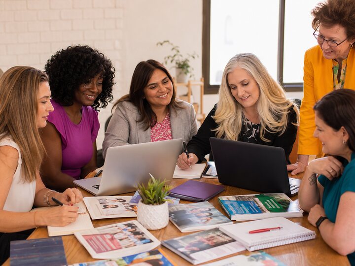 Women planning and organizing resources together for community impact.